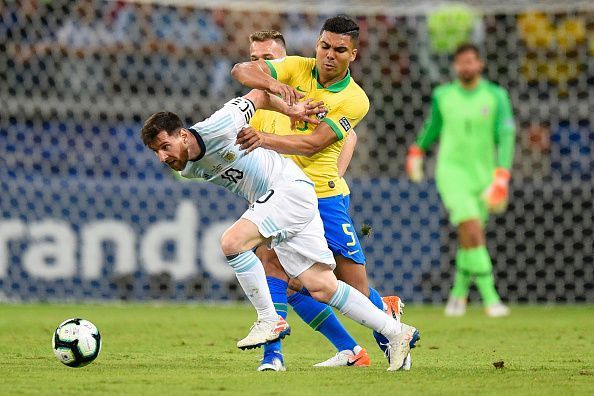 Casemiro holds Messi down.