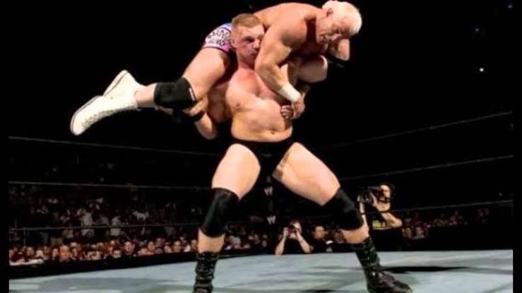 Lesnar lifting Bob Holly during their match on SmackDown