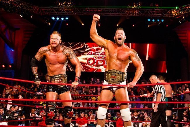Morgan (right) with Crimson as the TNA World Tag Team Champions.