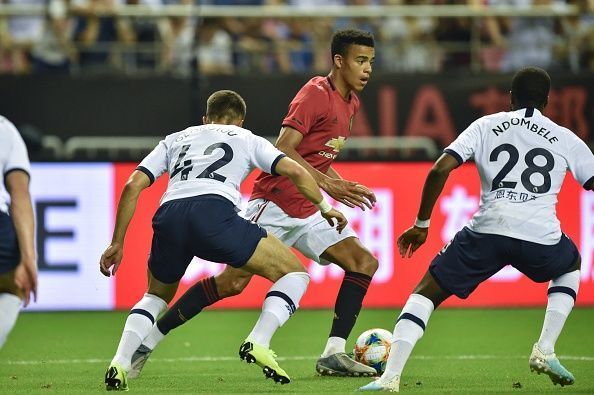 Mason Greenwood dribbles past Tottenham players