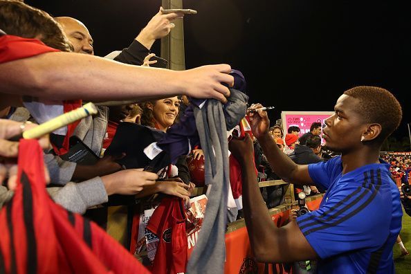 Manchester United players meet with fans.