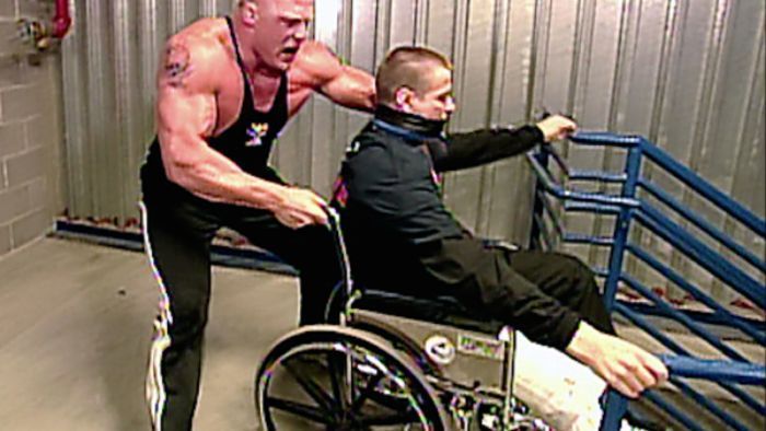 Brock Lesnar about to push a one-legged man down the stairs