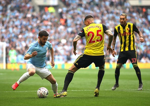 Manchester City&#039;s Silva dribbling to get pass Watford players