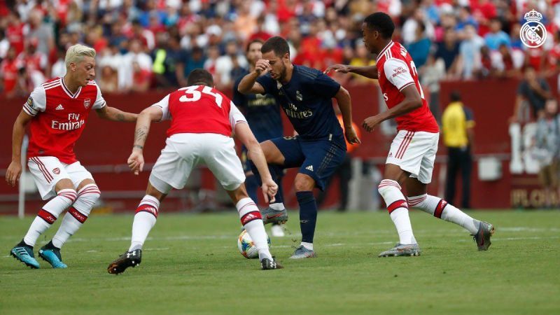 Eden Hazard surrounded by Arsenal players