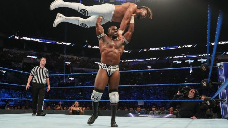 Apollo Crews lifts Andrade into a gorilla press slam