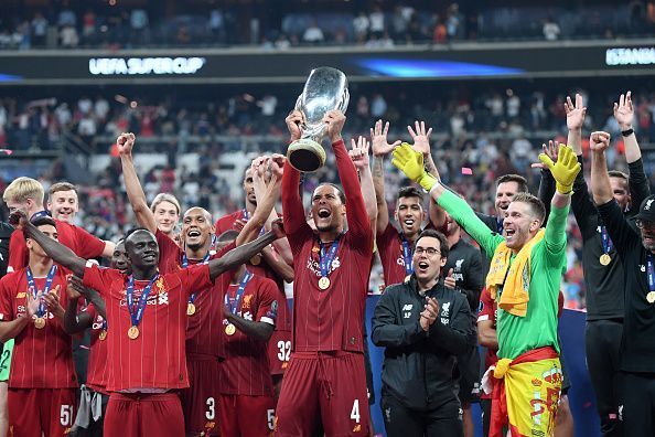 Virgil van Dijk holding the UEFA Super Cup for Liverpool