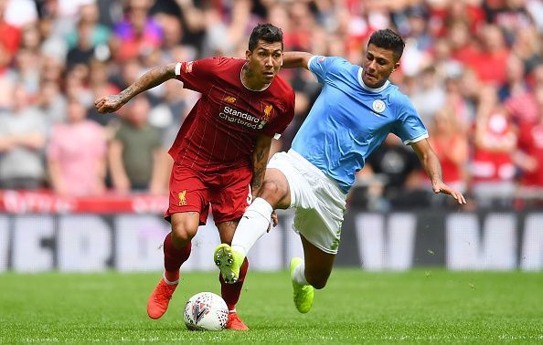 Roberto Firmino tussles with Rodri.