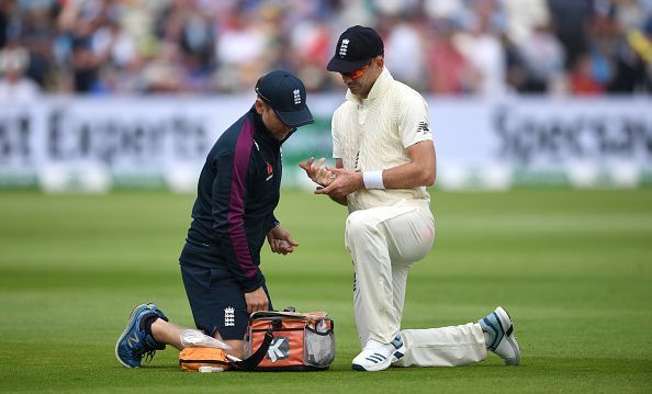 Jimmy Anderson receiving treatment for his &#039;tight calf&#039; during the first session of the first Ashes Test at Edgbaston