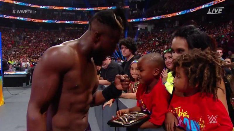 Kofi Kingston goes to his family after the match