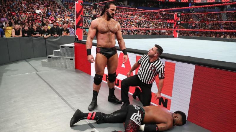 Drew McIntyre looks over a beaten down Cedric Alexander