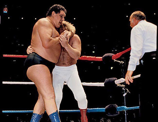 Andre the Giant traps Big John Studd in a head lock