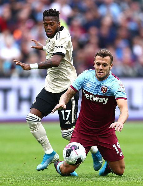 Fred in a tussle with Jack Wilshere.