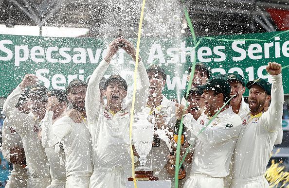 The Australian players celebrate after retaining the urn