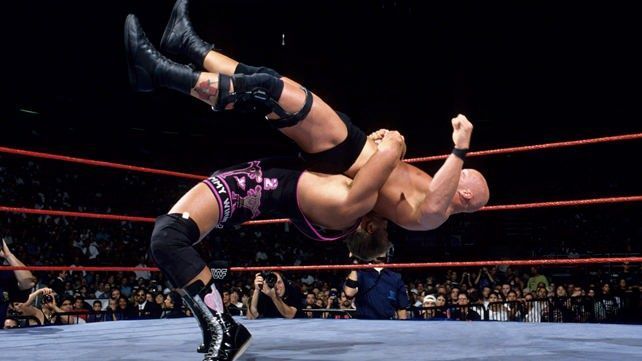 Owen Hart hefts Austin for a german suplex.