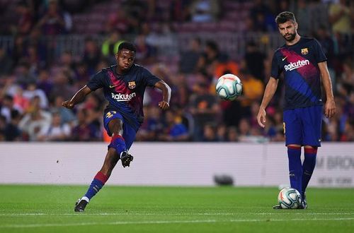 FC Barcelona's Ansu Fati (L) and Gerard Pique (R)