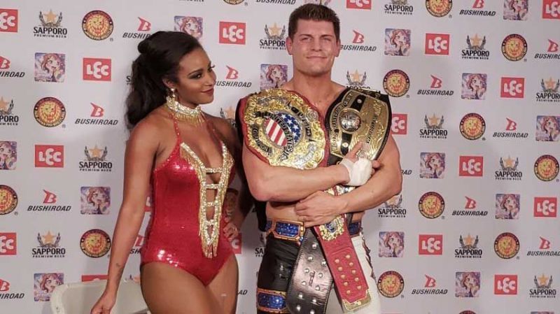 Cody with the IWGP US and the NWA World Championship along with his wife Brandi Rhodes