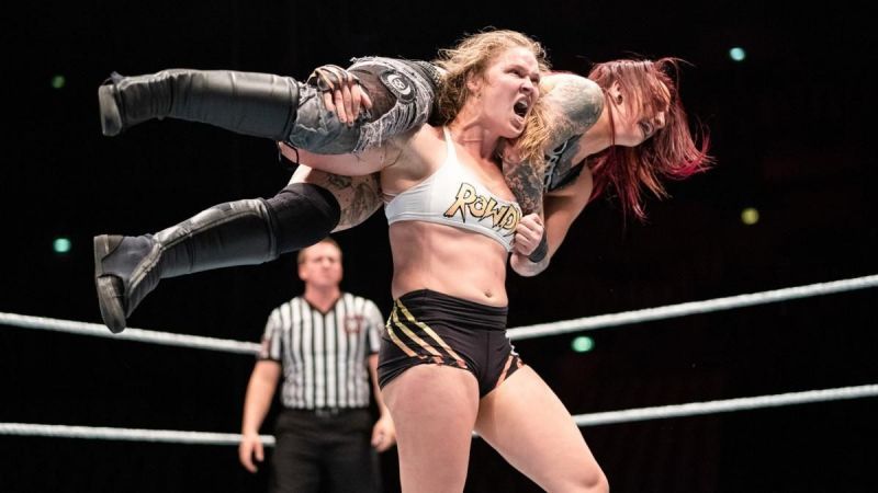 Former RAW Women&#039;s Champion Ronda Rousey hoisting Ruby Riott