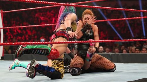 Asuka spitting green mist on Becky Lynch's face