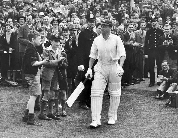 Donald Bradman coming out to bat.