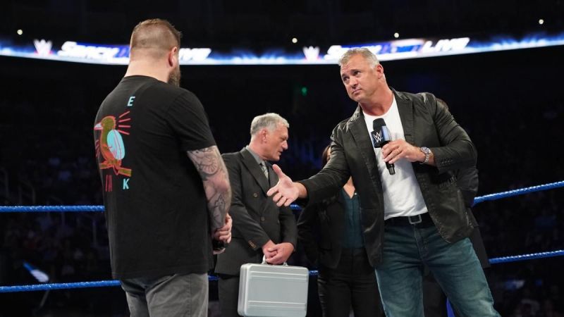 Shane McMahon offers a hand to Kevin Owens