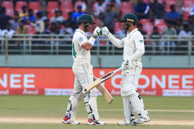 Dean Elgar punches gloves with Quinton de Kock after completing a valiant 100-run partnership.