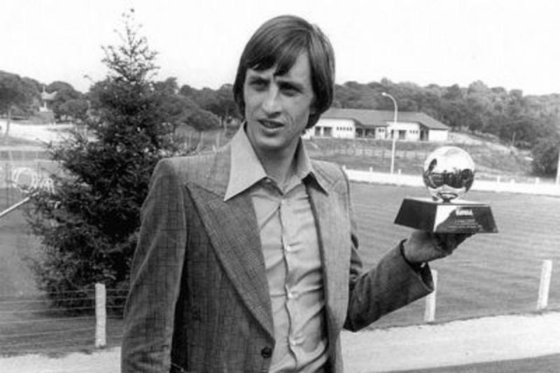 Johan Cruyff poses with one of his Ballon d'Or trophies