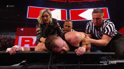 Renee Young tending to Jon Moxley