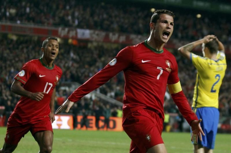 Cristiano Ronaldo exults after scoring in a 2014 FIFA WC qualifier playoff against Sweden