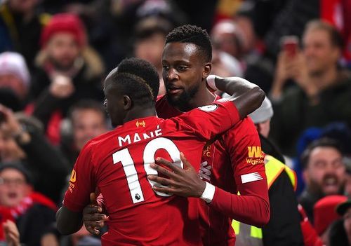 Divock Origi celebrates one of his goals with Sadio Mane during Liverpool's 5-2 Merseyside Derby win