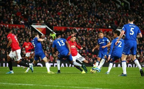 Manchester United's Mason Greenwood against a barrier of Everton players