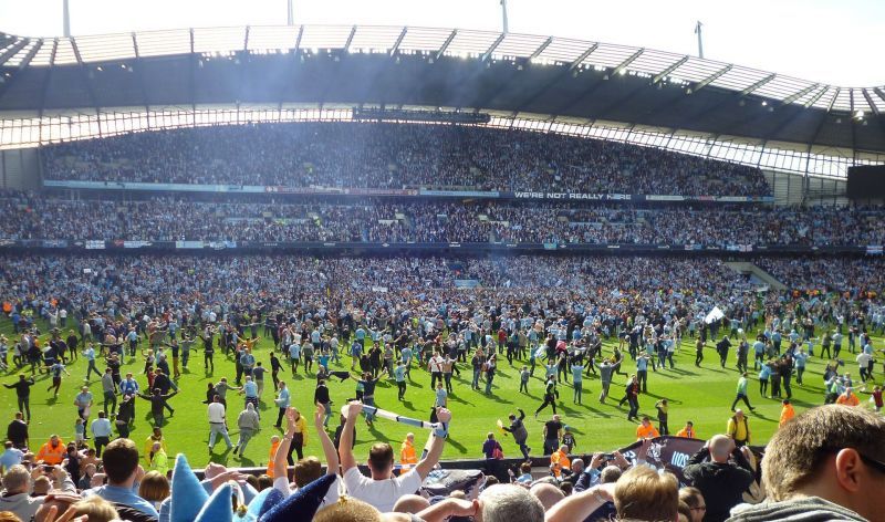 Delirious fans invade the pitch after Manchester City won the Premier League in 2011-12