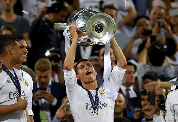 Ronaldo with the Champions League trophy in Real Madrid colours