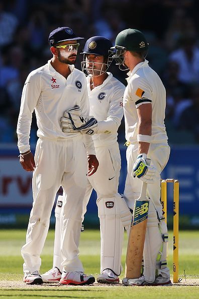 Virat Kohli (L) with Wriddhiman Saha (middle)