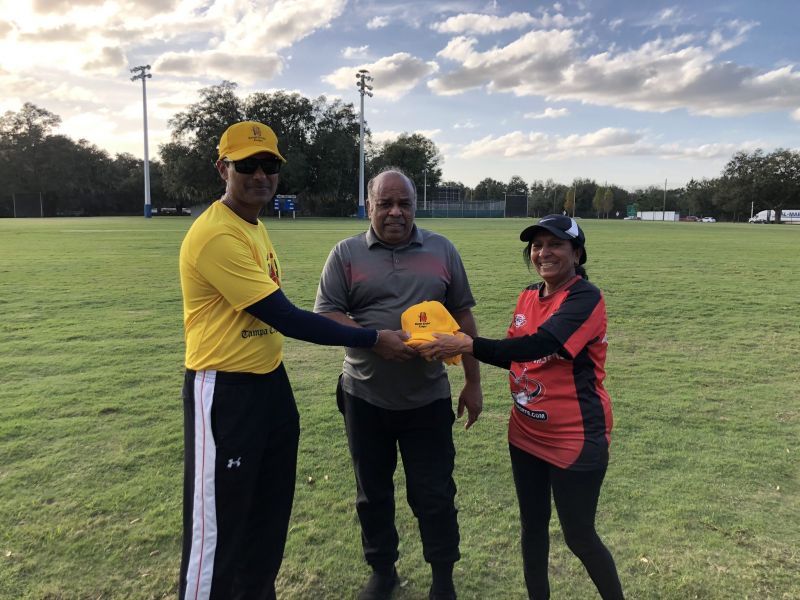 Nitesh Shetty, President TCL present TCL cap &amp; Shirt to Coach Jatin Patel with Jyotsna Patel