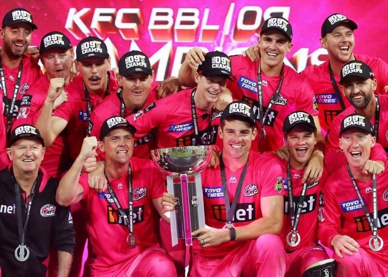 Skipper Moises Henriques posing with the BBL trophy after Sydney Sixers won BBL 2019-20.