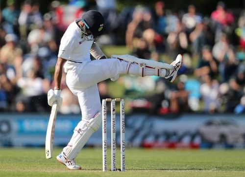 Cheteshwar Pujara kicks the turf in disgust.