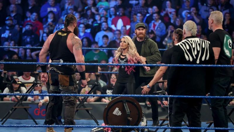 Sami Zayn using Alexa Bliss as a shield