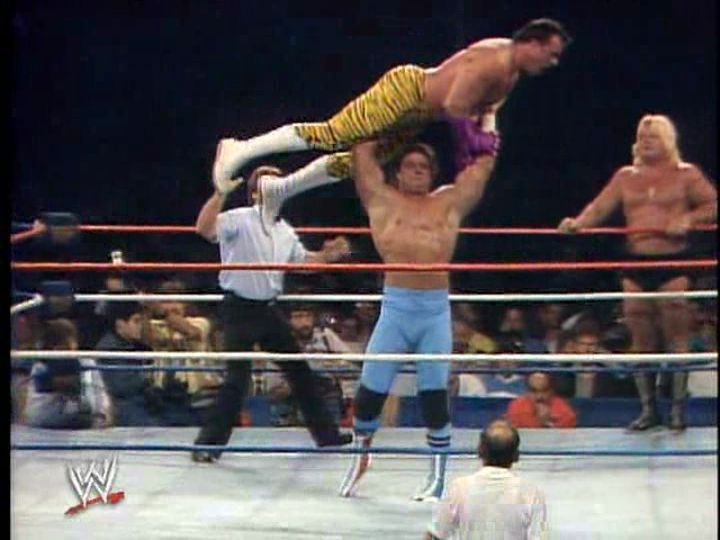 Davey Boy Smith puts a pre-Barber Brutus Beefcake up in the lights at Wrestlemania II