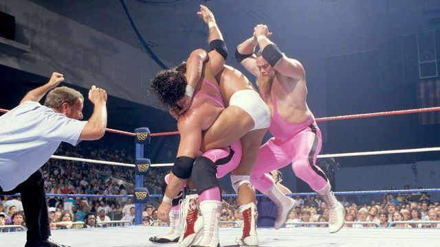 Trapped in an abdominal stretch, Bret Hart is rescued by partner Jim Neidhart