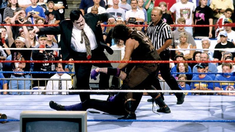 The Undertaker is beaten down by Bearer and Mankind