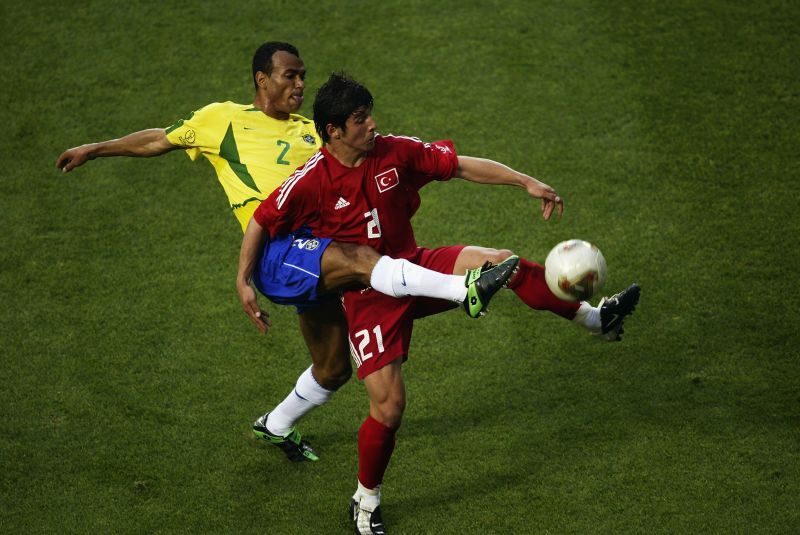 Cafu of Brazil challenges Emre Belgozoglu of Turkey