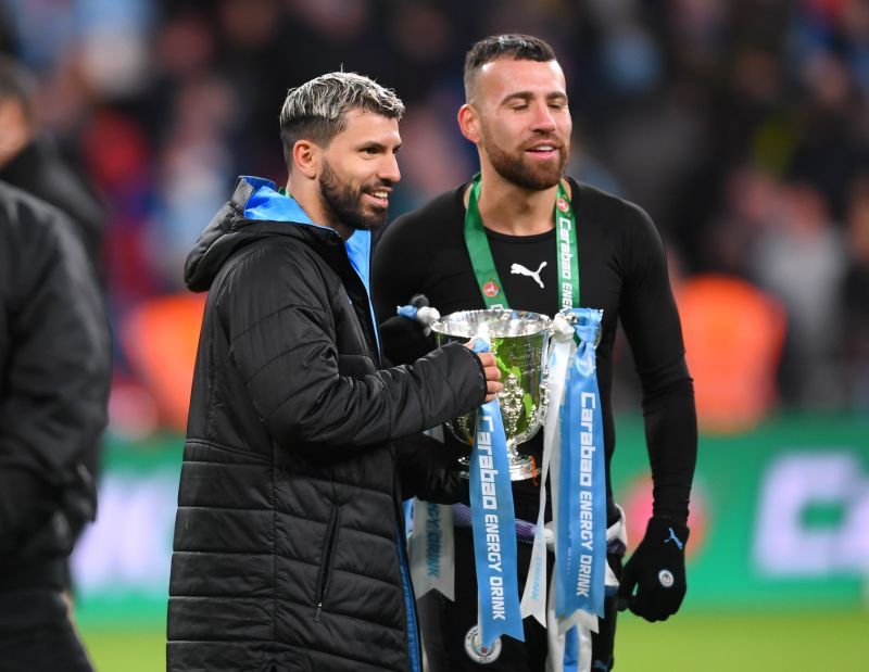 Otamendi poses for pictures with compatriot Sergio Aguero after their Carabao Cup victory in February