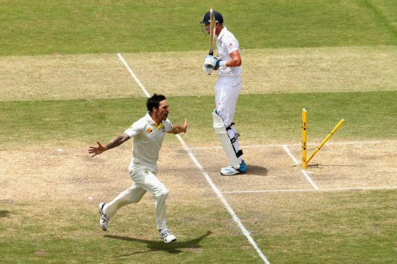 Mitchell Johnson celebrates after messing up Stuart Broad's leg-stump