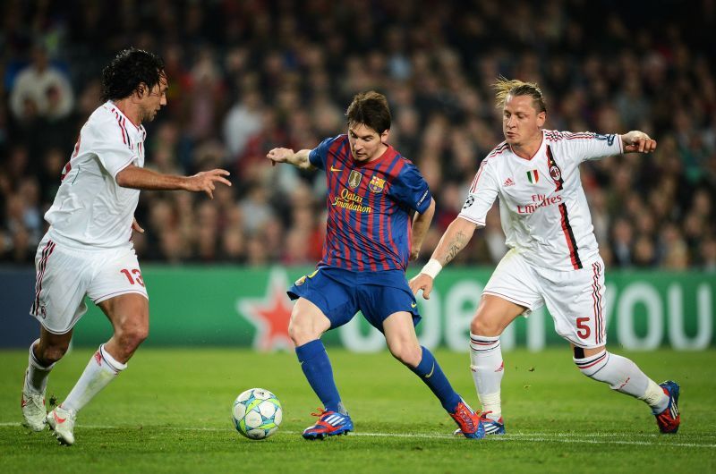 Alessandro Nesta (left) looks on as Lionel Messi goes past Phillipe Mexes