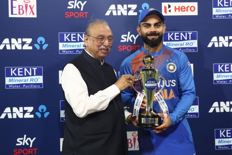 Virat Kohli (right) accepting the trophy after a T20 series win over New Zealand earlier this year