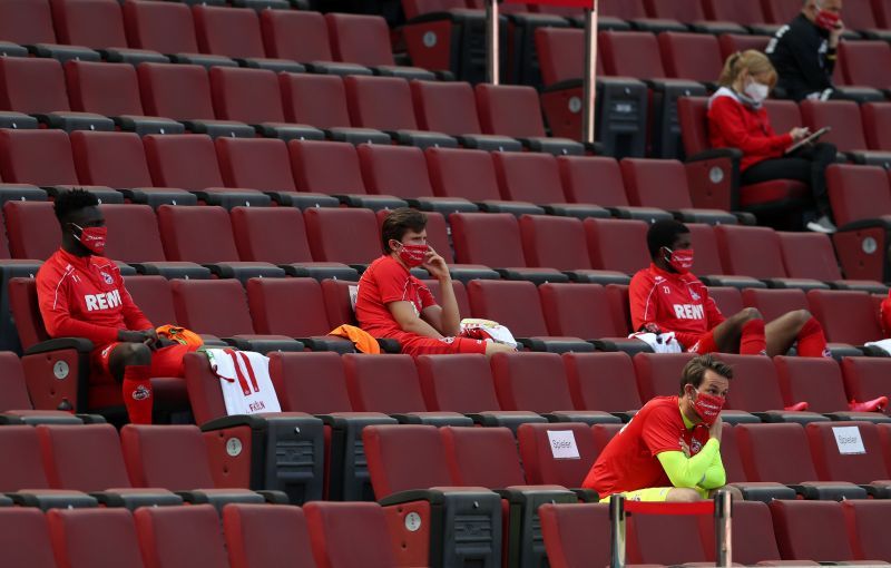 Players on the bench sitting separately as part of the social distancing protocols