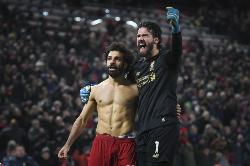 Alisson celebrating with Mo Salah after assisting the Egyptian for Liverpool&#039;s second goal against Man Utd