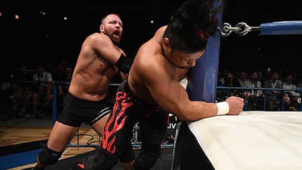 Moxley pushing Shingo Takagi into the ring post