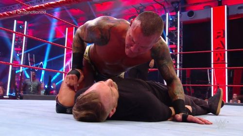 Randy Orton hovers over Christian on WWE RAW