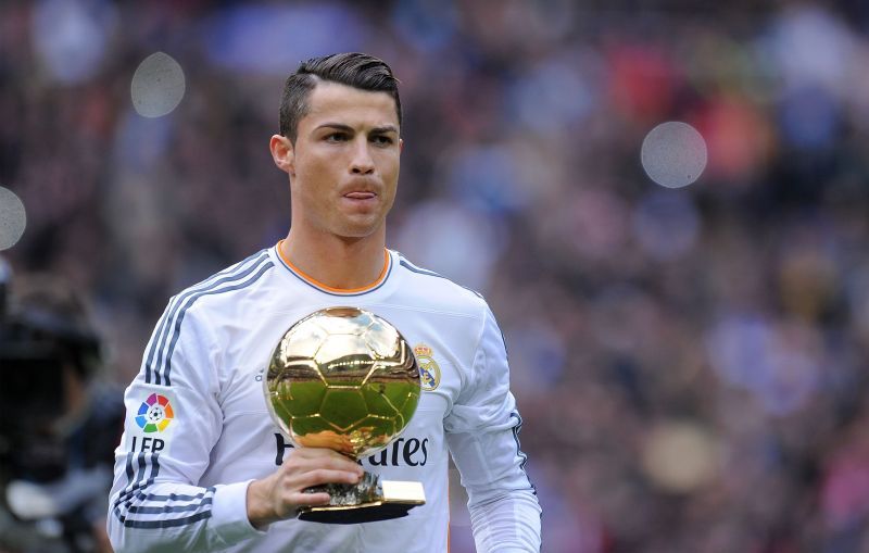 Cristiano Ronaldo showcasing his Ballon d&#039;Or trophy at the Bernabeu in 2013